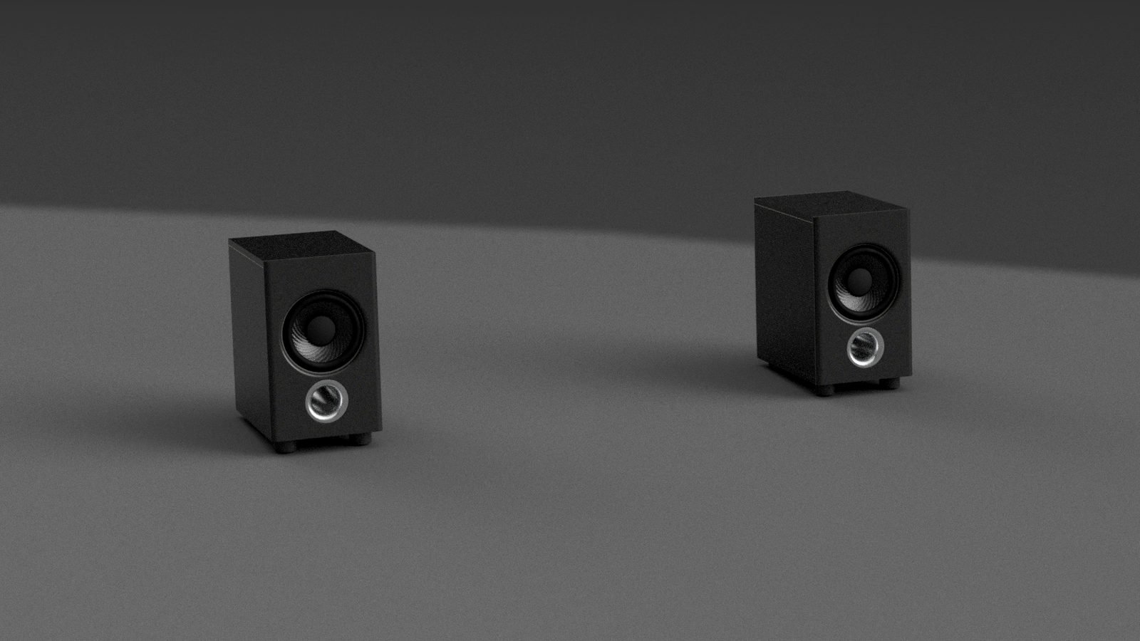 CAD render of two small black satellite speakers side by side on a grey surface. Each has a single full-range driver with a carbon-pattern cone and, below it, a round port with a metal ring.